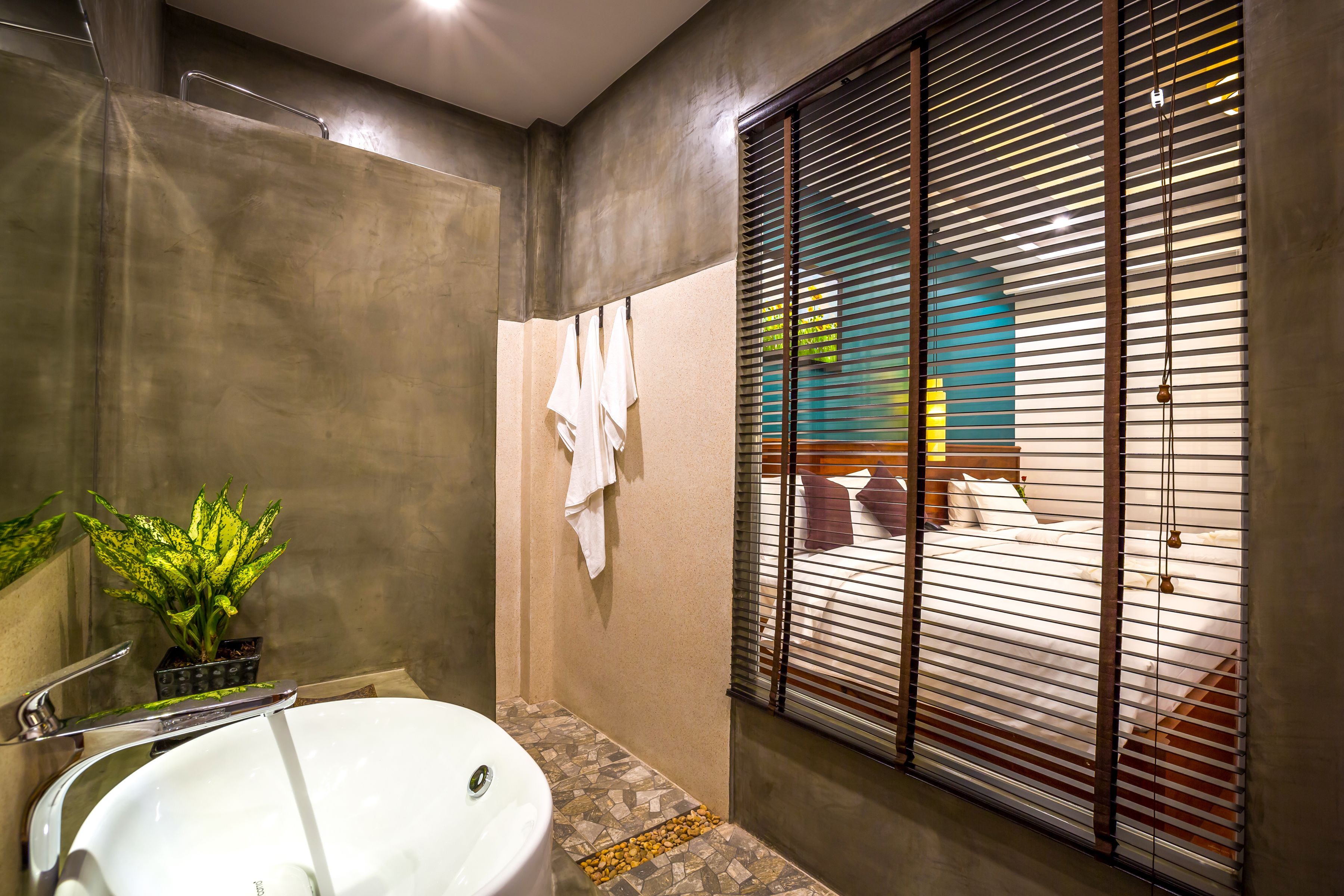 family landmark suite - pool view | bathroom | free toiletries, hair dryer, bathrobes, slippers