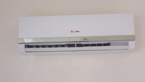 A white wall-mounted air conditioning unit with a control panel and a brand name visible. - Pinara Pension & Guesthouse (Fethiye)