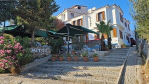 A stone staircase leading to a building with a sign reading "MITOS". - Mitos Hotel (Bozcaada)