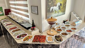 A buffet setup with various food items and condiments. - Hotel Santana Life (Edremit)