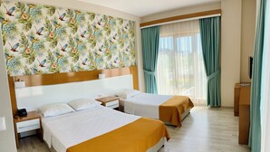 A hotel room with two beds, a wooden headboard, a tropical wallpaper, and a large window with curtains. - Hotel Santana Life (Edremit)