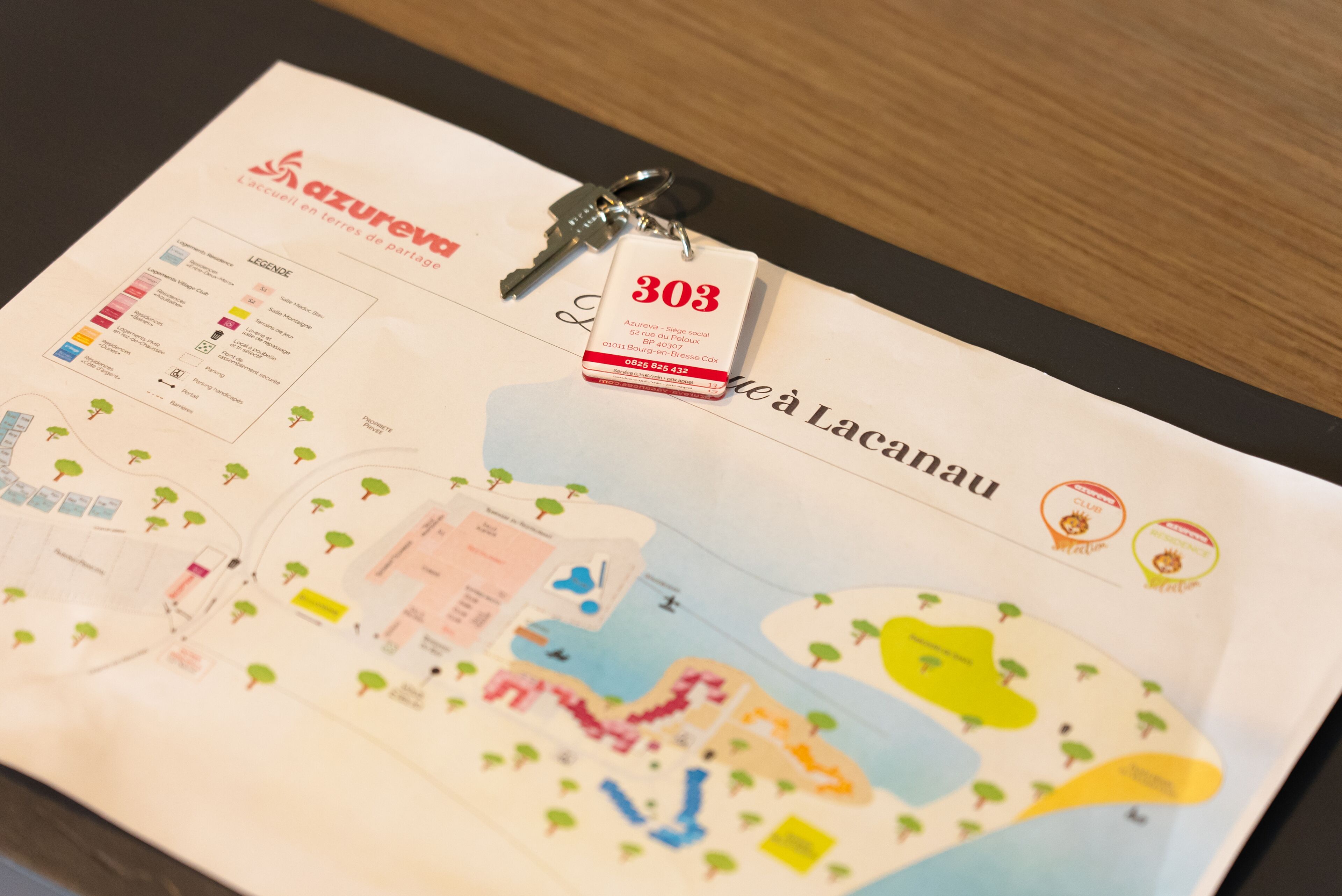 A hotel brochure with a map, key, and a tag with the number 303.