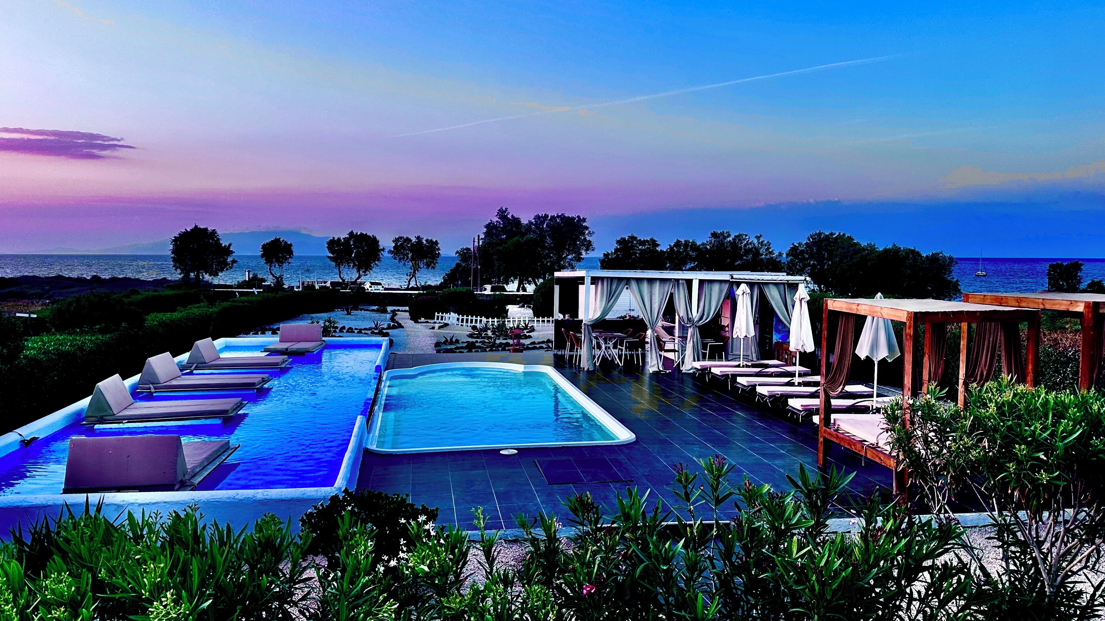 Seasonal outdoor pool, open 7:00 AM to 9:00 PM, pool umbrellas