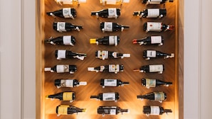 A wine rack with multiple bottles of wine.