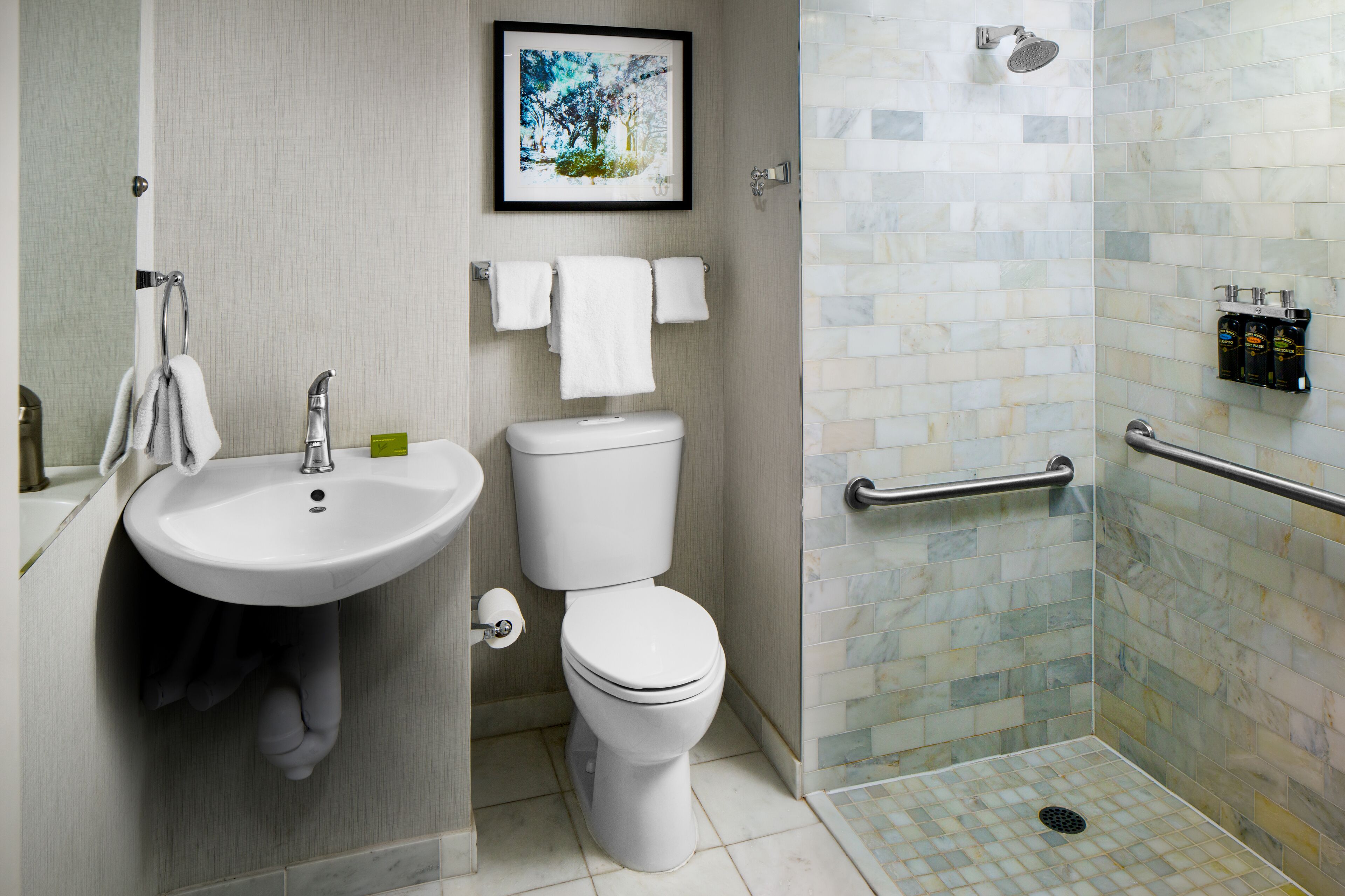 A bathroom with a sink, toilet, and shower.