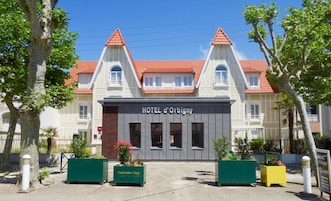 A hotel with a classic architectural style, featuring a symmetrical facade with two towers and a central entrance.