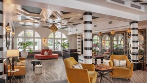 A spacious lobby with a patterned floor, a large chandelier, and a chess table. - Hotel Californian (Santa Barbara)