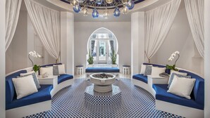 A lobby with a central seating area, a patterned floor, and a decorative ceiling. - Hotel Californian (Santa Barbara)