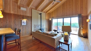 A wooden interior with a sofa, dining table, and chairs. - Hills Terrace Hakodate (Mori)