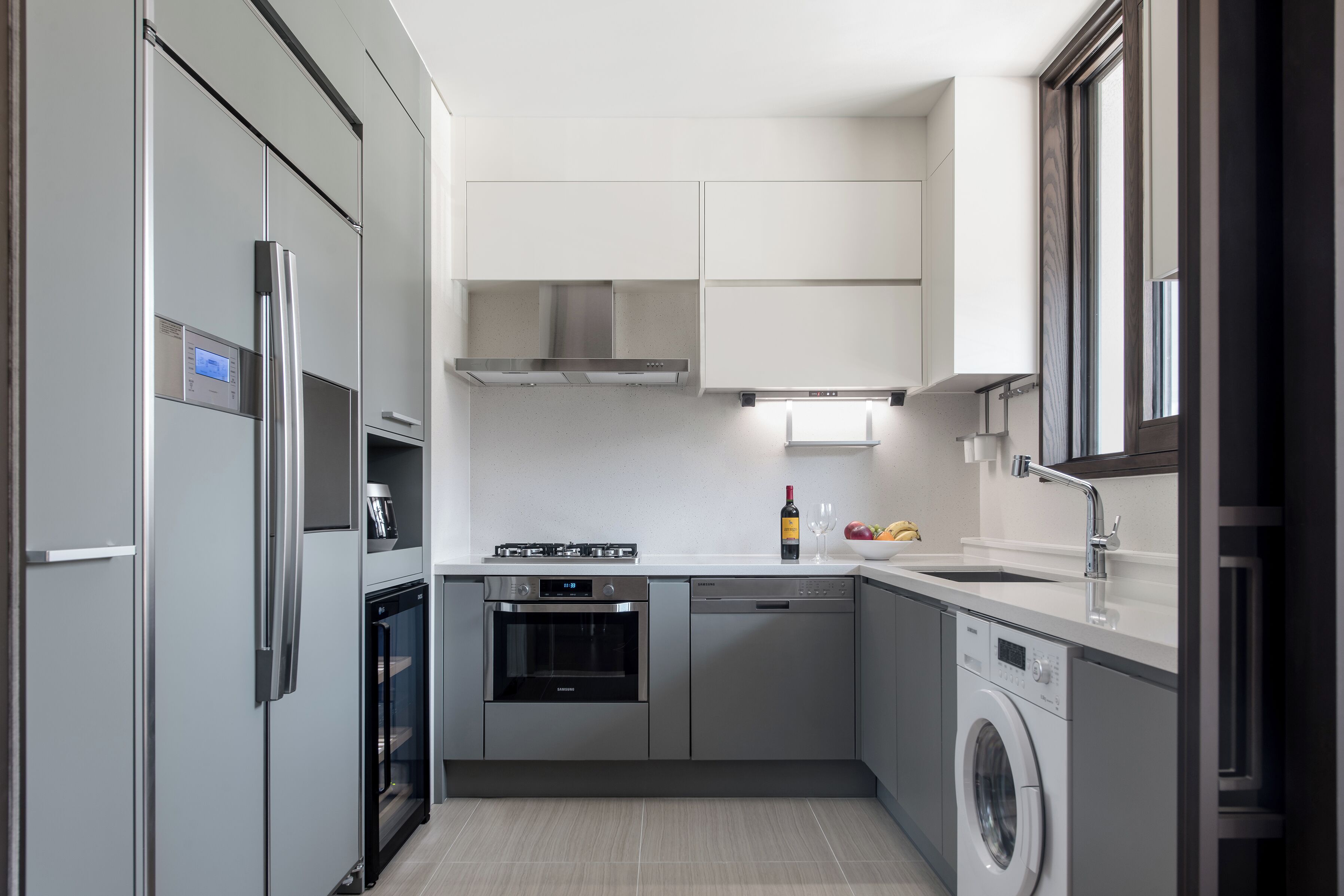 A modern kitchen with stainless steel appliances, a dishwasher, and a built-in oven.
