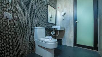 A modern bathroom with a toilet, sink, and mirror.