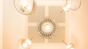 A ceiling with four spherical light fixtures and a central circular light fixture.