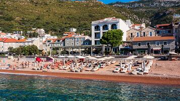 On the beach, sun loungers, beach umbrellas, beach towels