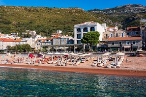 On the beach, sun loungers, beach umbrellas, beach towels