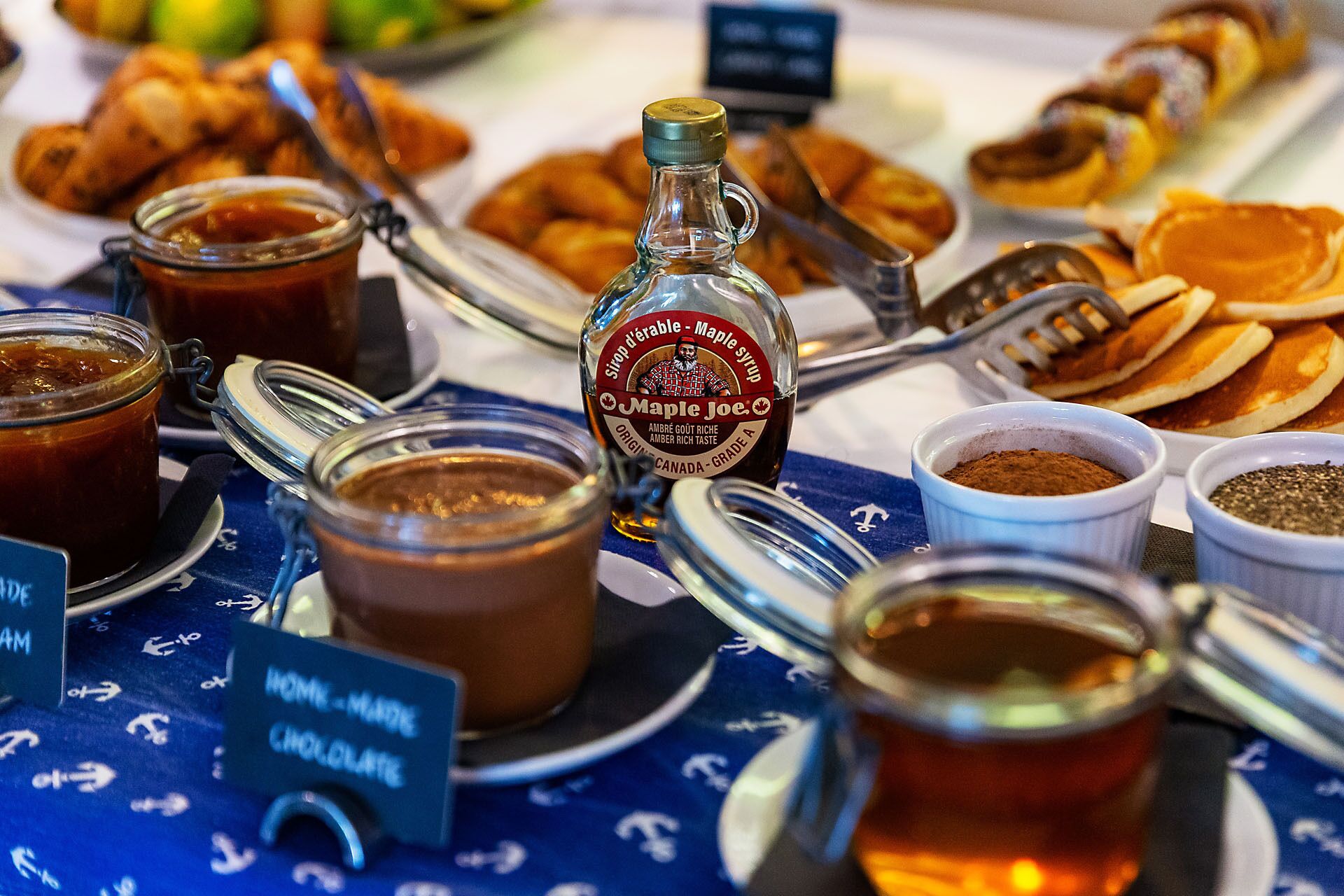 A breakfast buffet with various food items and condiments.