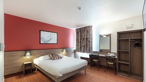 A hotel room with a bed, desk, chair, wardrobe, and a painting on the wall. - ACE Hôtel Chartres (Le Coudray)