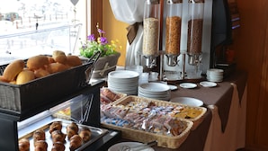 A breakfast buffet with bread, pastries, and cereal options. - Hotel Loredana (Livigno)