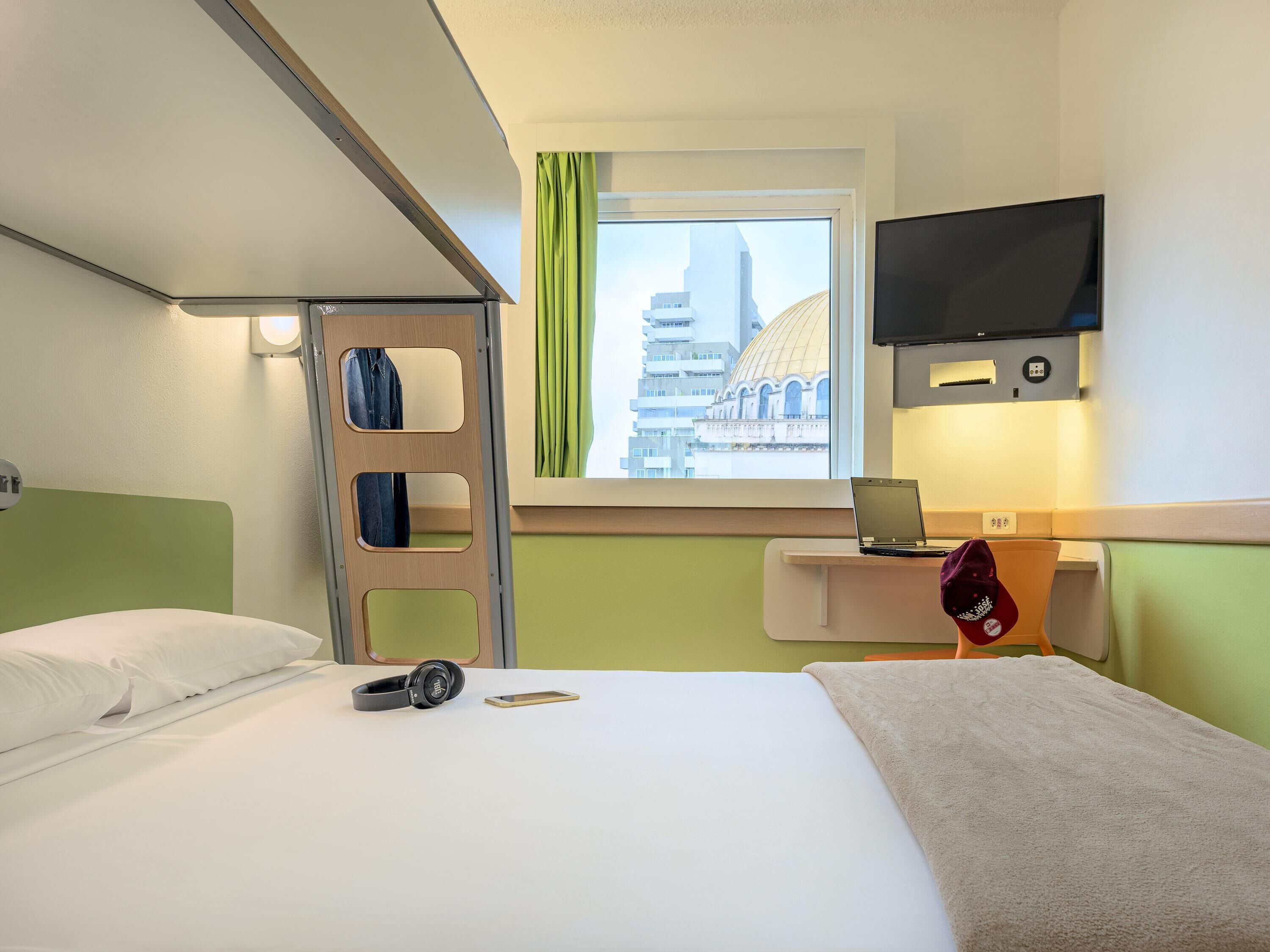 Hypo-allergenic bedding, desk, laptop workspace, blackout drapes