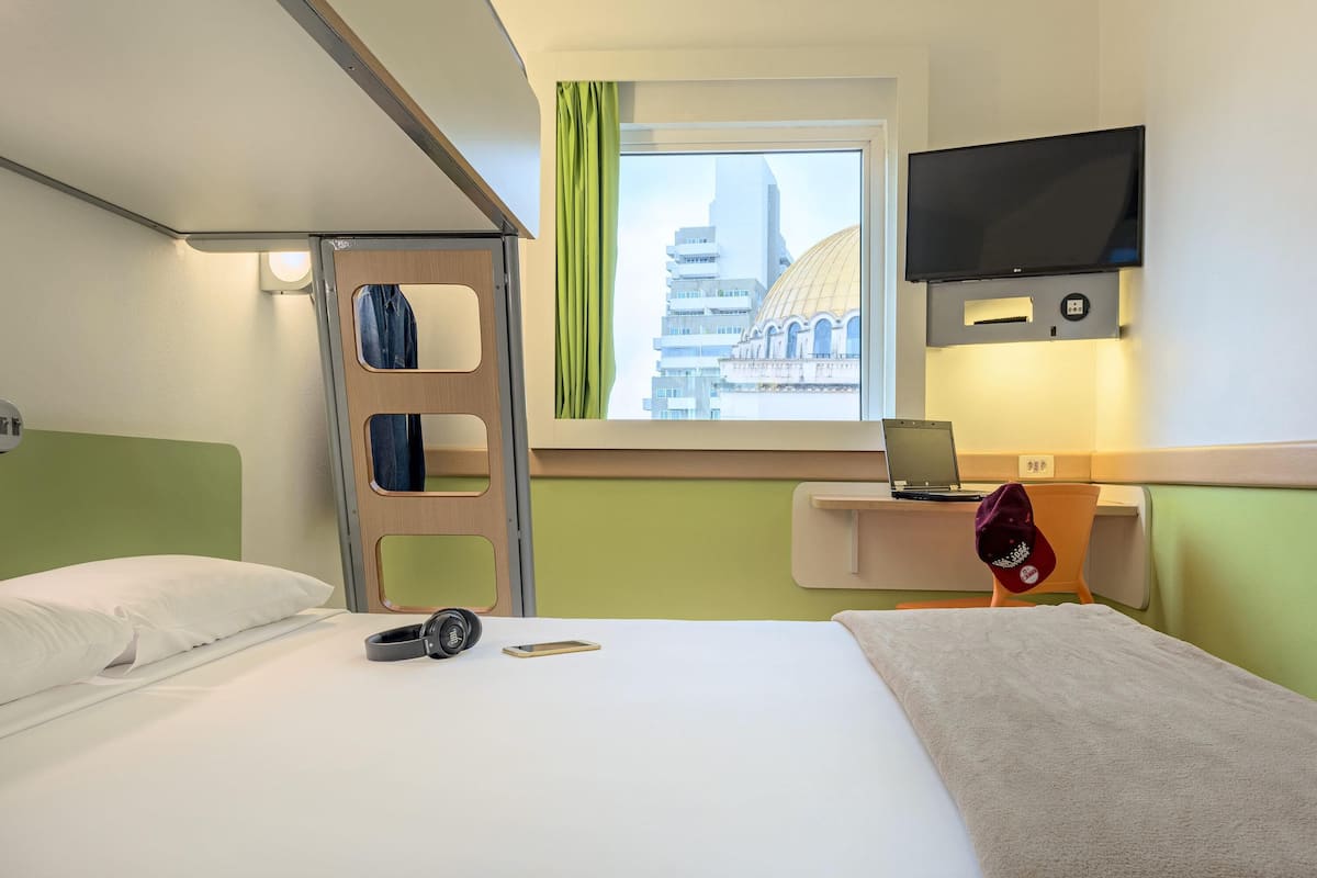 Hypo-allergenic bedding, desk, laptop workspace, blackout drapes