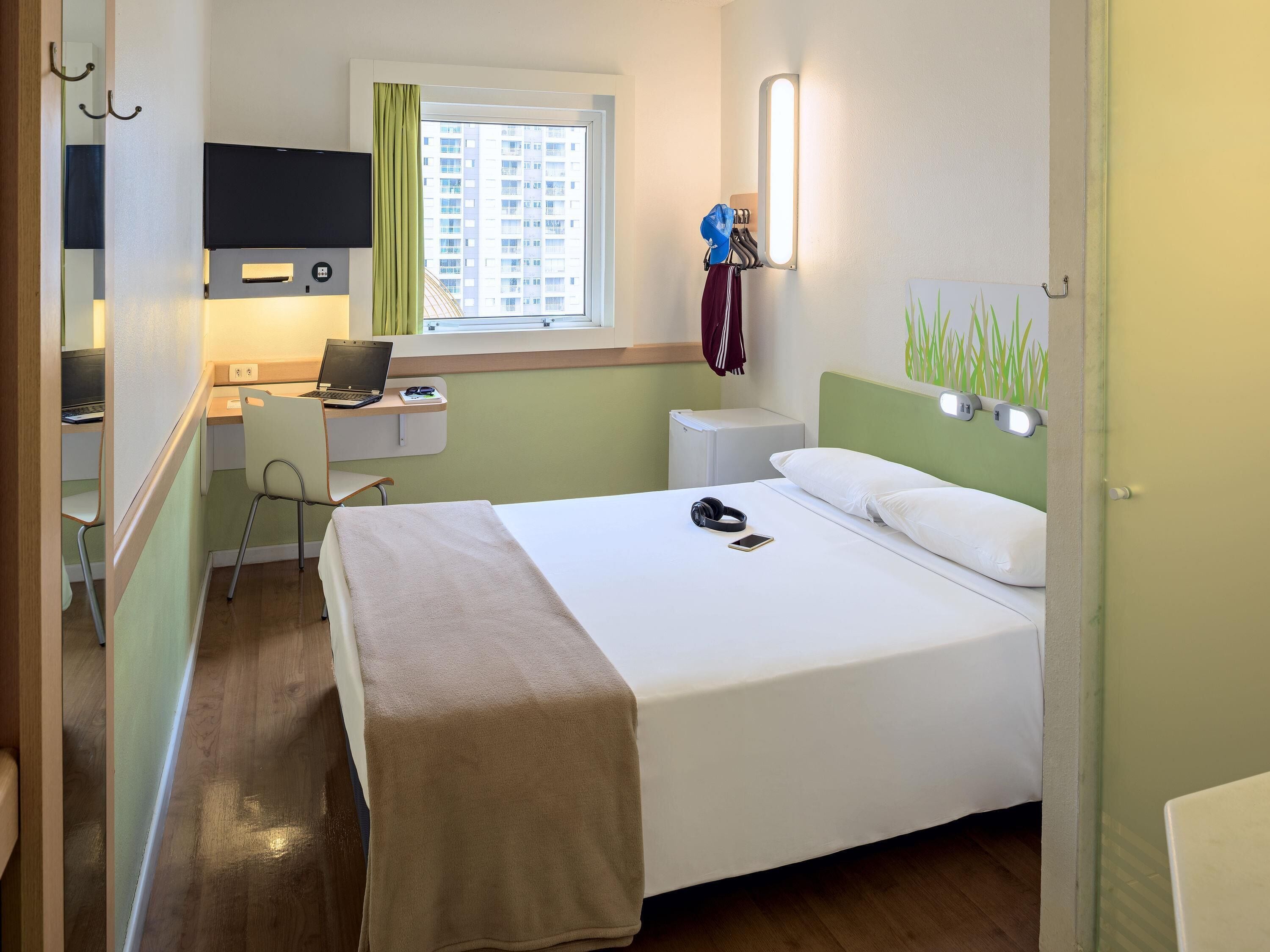 Hypo-allergenic bedding, desk, laptop workspace, blackout curtains