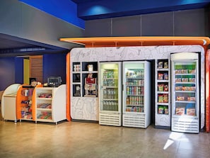 Convenient retail area with vending machines and refrigerated display cases offering a variety of snacks and beverages.