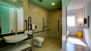 A modern bathroom with a sink, toilet, and shower.