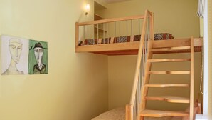 A bunk bed with a wooden ladder and a small, fluffy rug at the foot. - Great Apartment near Town Hall (Vilnius)