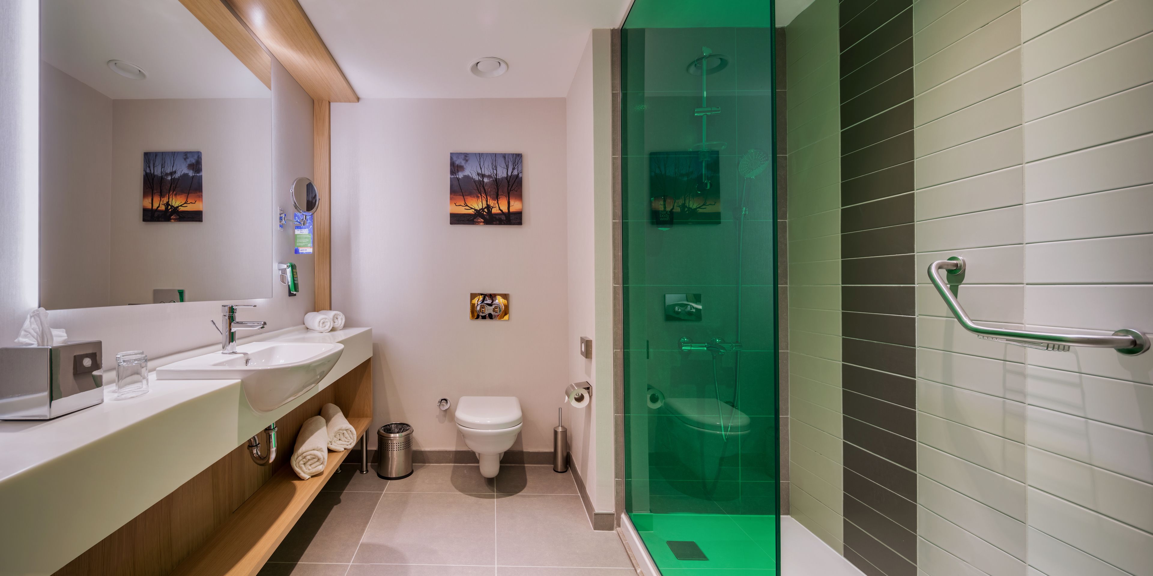 A modern bathroom with a glass-enclosed shower, a sink, and a toilet.