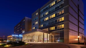 A modern hotel with a glass facade, multiple floors, and a well-lit entrance. - Park Inn by Radisson Samsun (Tekkekoy)