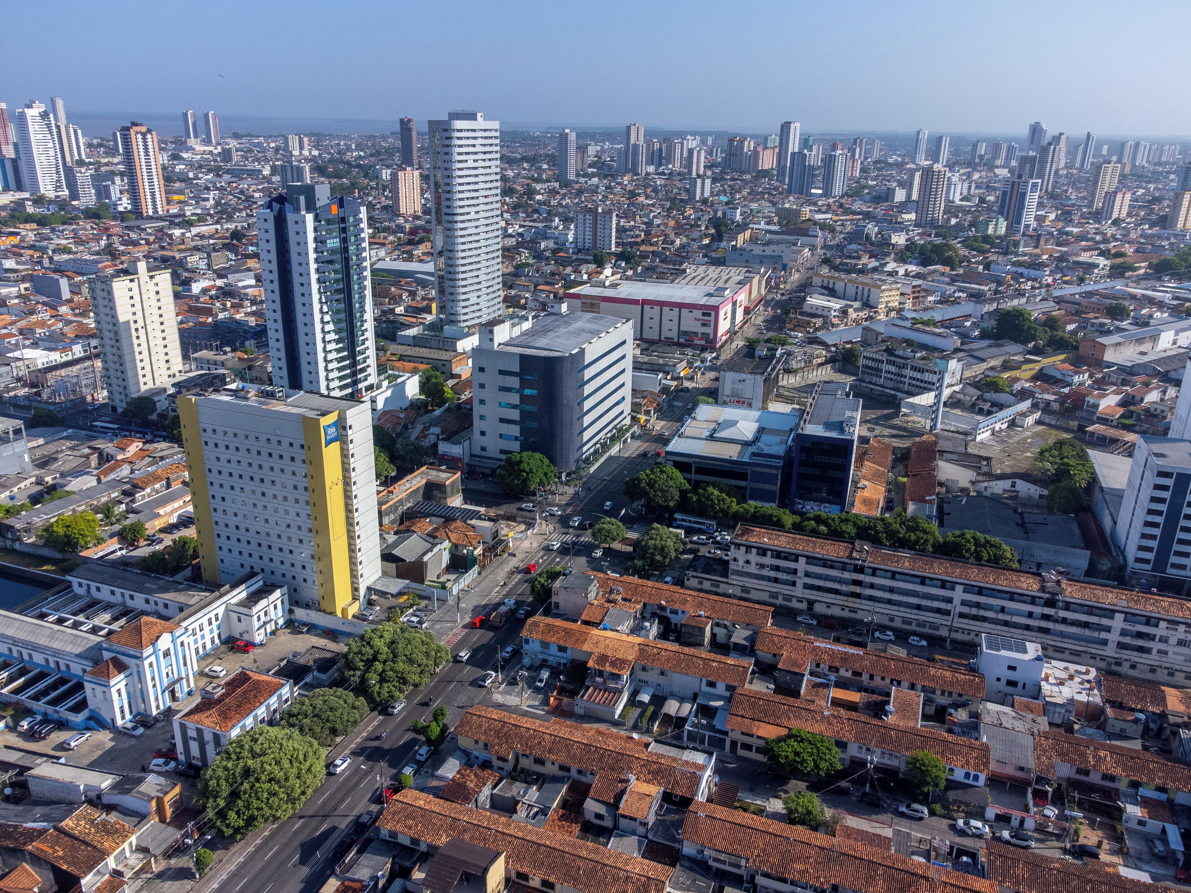 A cityscape with a mix of high-rise buildings and low-rise structures, featuring a variety of architectural styles.