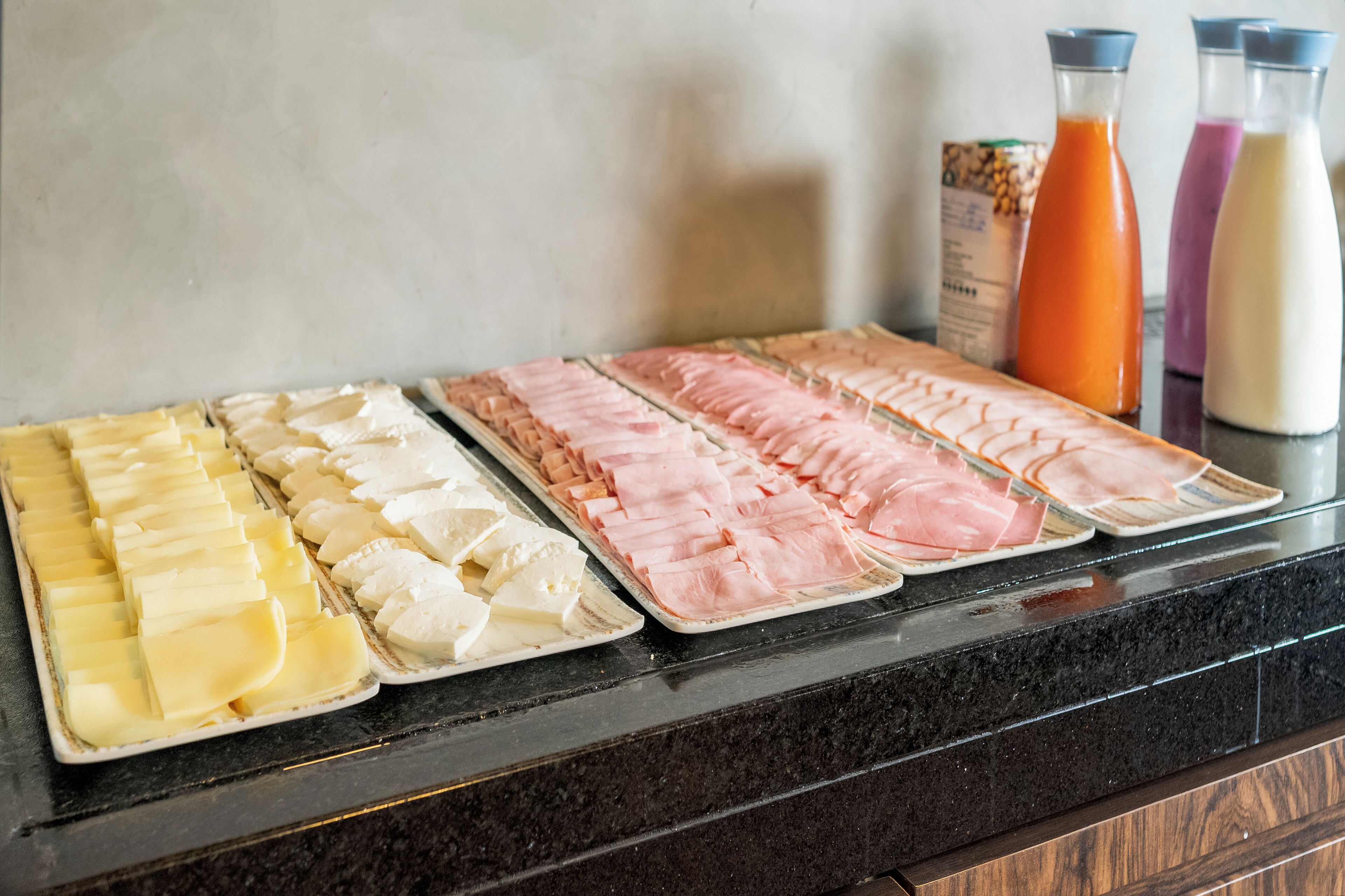 A buffet with various food items and beverages.