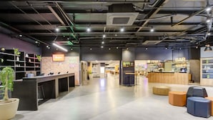 Een modern interieur met een receptiebalie, een bar en zitplaatsen.