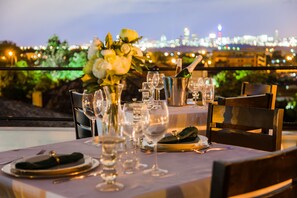 A table set for dining with a city view in the background. - Heavenly Boutique Guesthouse (Johannesburg South)