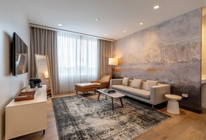 Deluxe Suite, 1 King Bed | Living room | 55-inch LED TV with satellite channels, TV - The Hotel at Midtown (Chicago)
