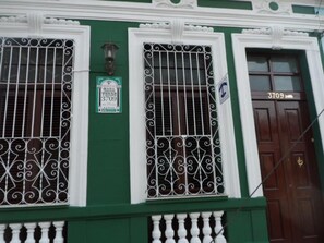 Stunning building facade with ornate metal grilles and decorative wall-mounted lights.