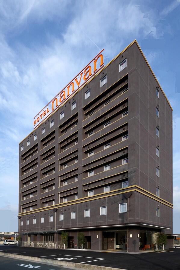 A modern hotel building with a prominent sign reading "Hotel Nanvan". It features multiple floors with balconies and a flat facade. - Hotel Nanvan Hamanako (Kosai)