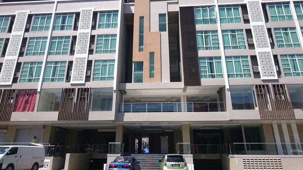 Un bâtiment moderne à plusieurs étages, doté de grandes fenêtres et de panneaux décoratifs.