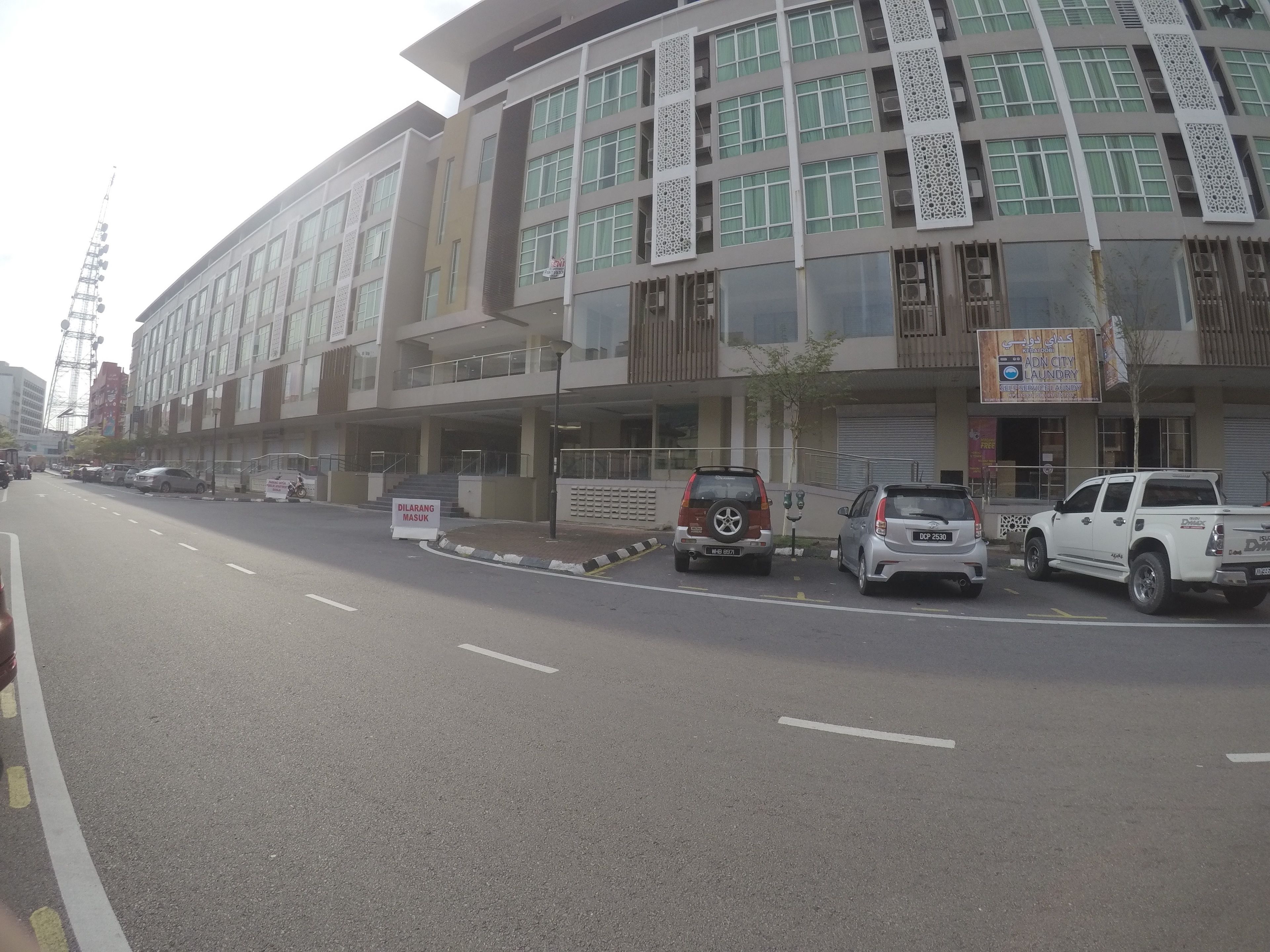 A multi-story building with a modern architectural design, featuring large windows and decorative panels.