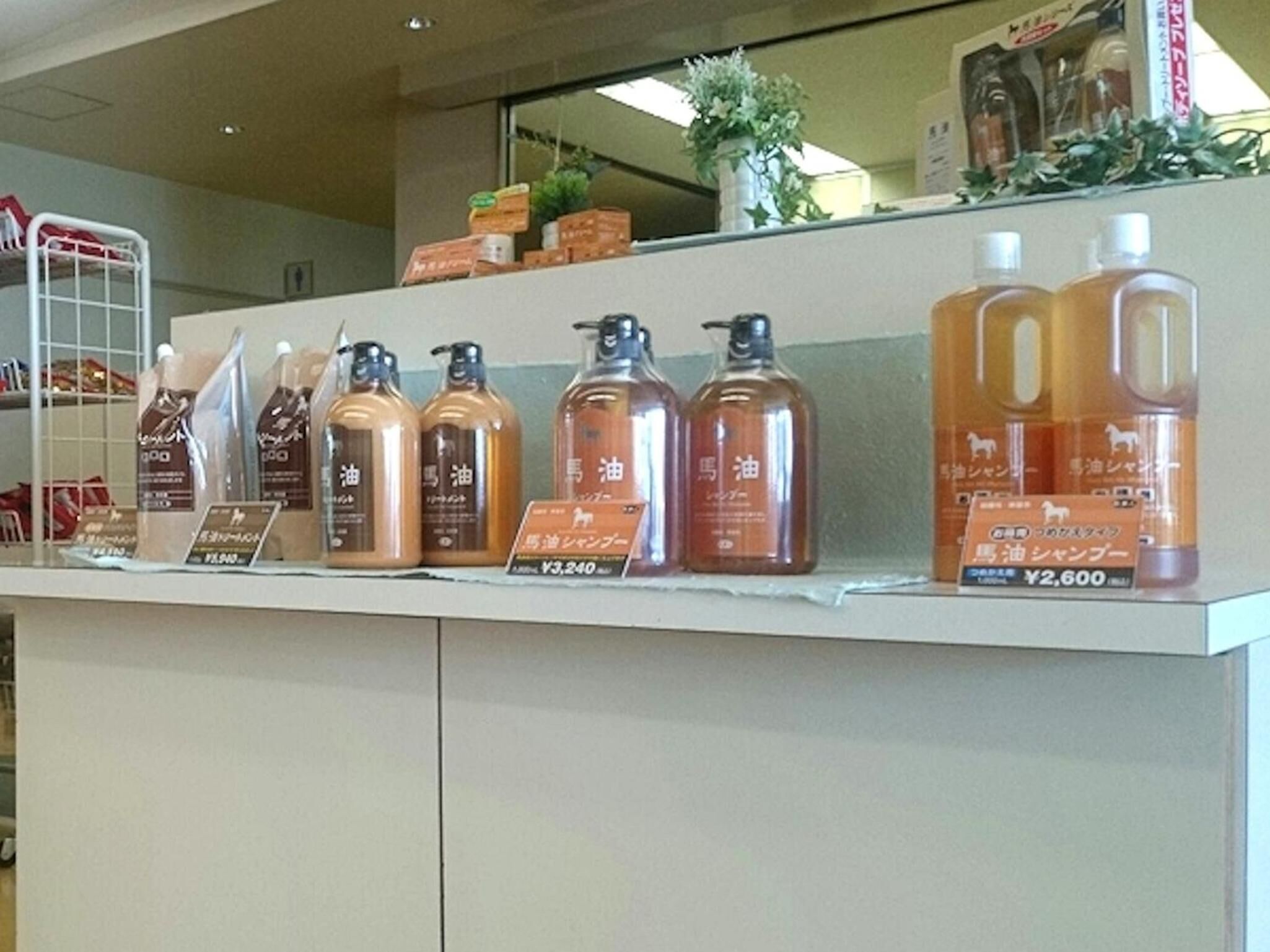 A display of various bottles of liquid products with price tags in a store.
