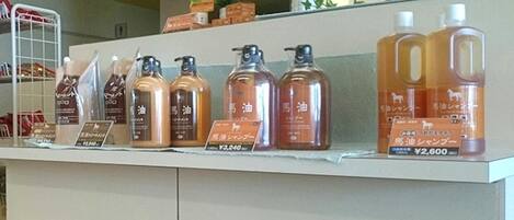 A display of various bottles of liquid products with price tags in a store.