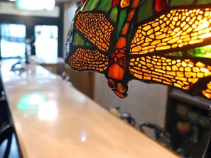 A close-up of a stained glass window with intricate patterns. - Gasthof Schi Heil (Nozawaonsen)