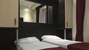 A hotel room with two single beds, a large mirror, and a wardrobe. - Sweety (Rome)