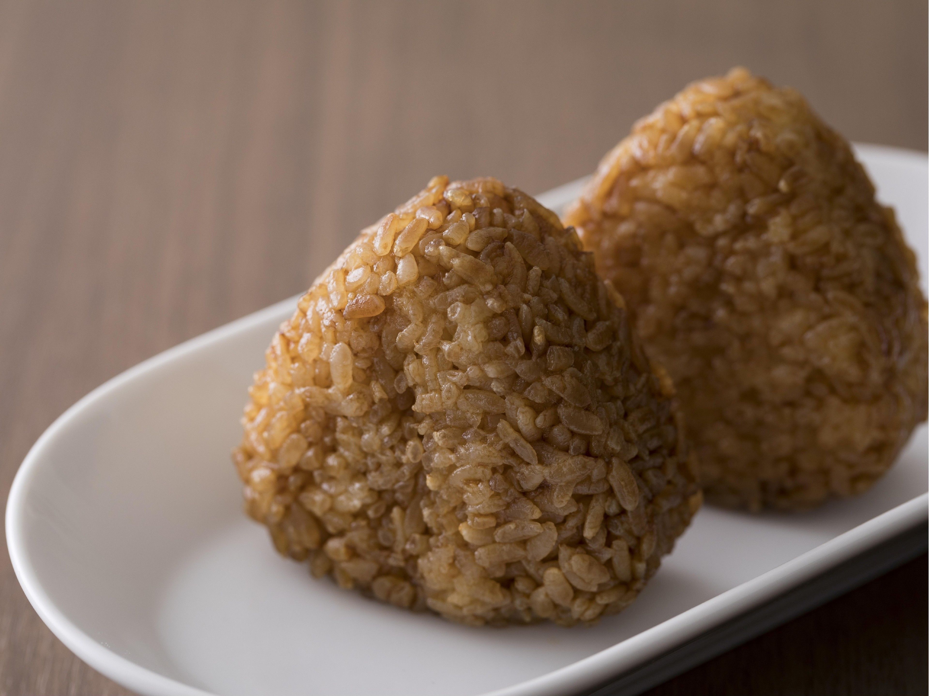 Dos bolas de arroz sobre un plato blanco.