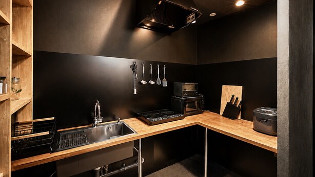 A modern kitchen with a black backsplash, wooden shelves, a stainless steel sink, and a black countertop. - Namba Guesthouse HIVE - Hostel (Osaka)