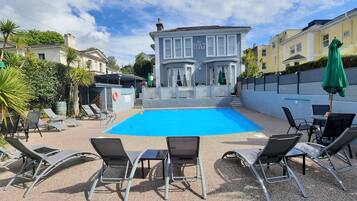 Seasonal outdoor pool, pool loungers