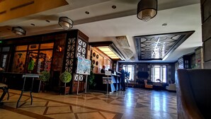 Un hall d’entrée comprenant un comptoir d’enregistrement, un bureau de réception et un espace détente.