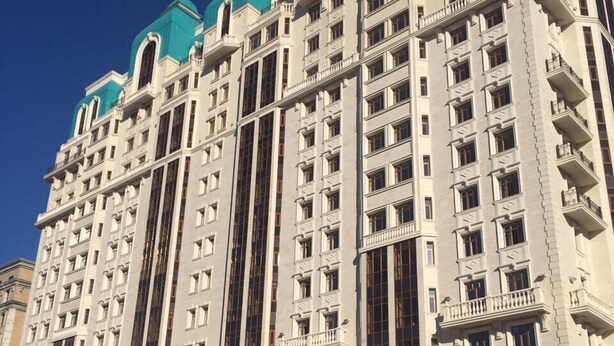A multi-story building with a prominent entrance, large windows, and a flat roof. - Alanda Hotel (Astana)