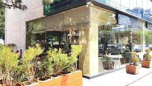 A modern building with a cafe named "3503 J CAFE" on the ground floor. - L Plaza Hotel (Tbilisi)