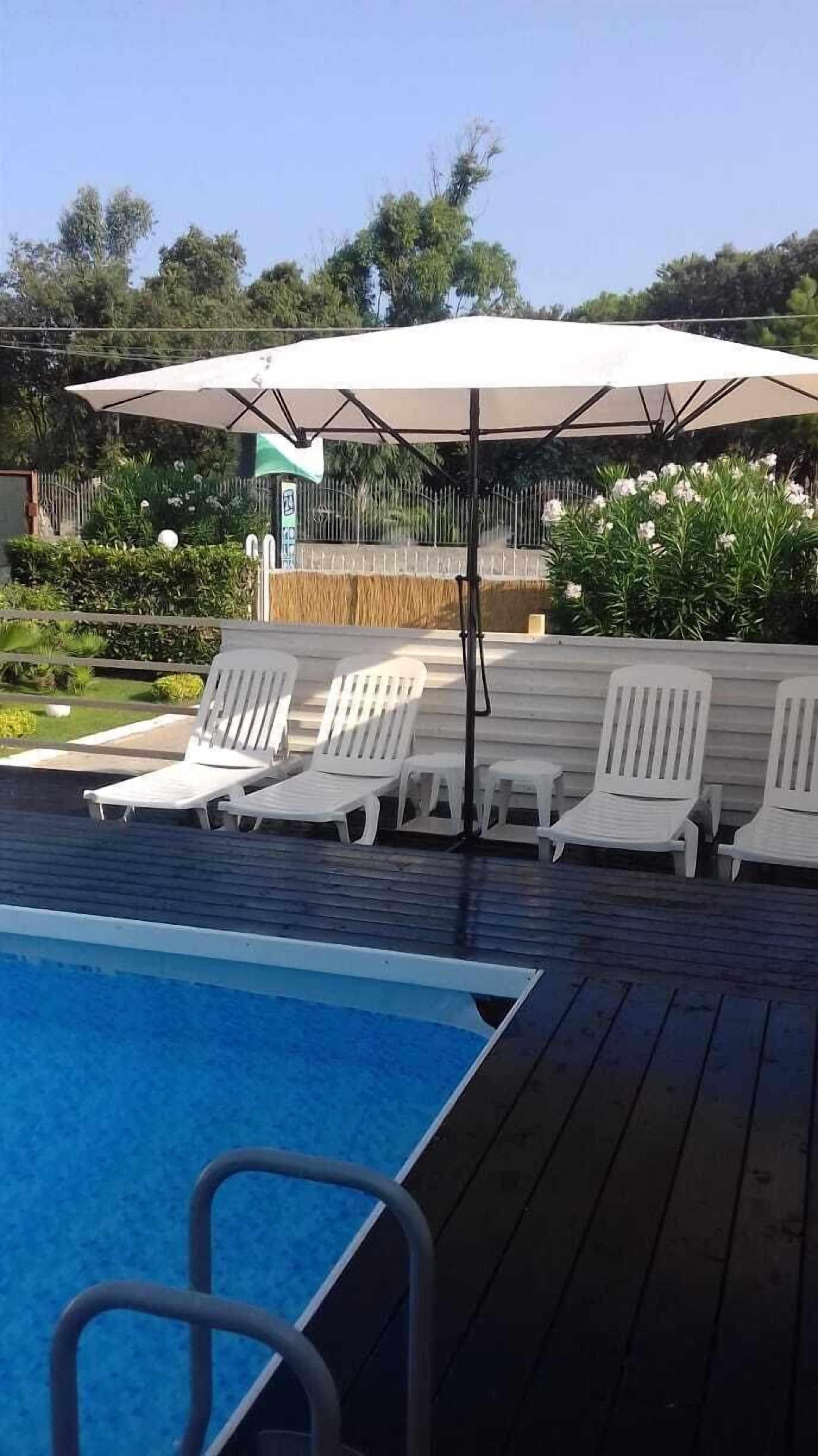 Seasonal outdoor pool, open 8:00 AM to 7:00 PM, pool loungers