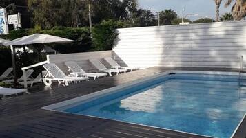 Seasonal outdoor pool, open 8:00 AM to 7:00 PM, pool loungers